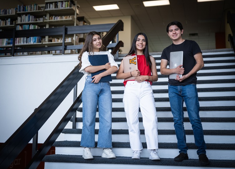 alumnos posan frente a escaleras